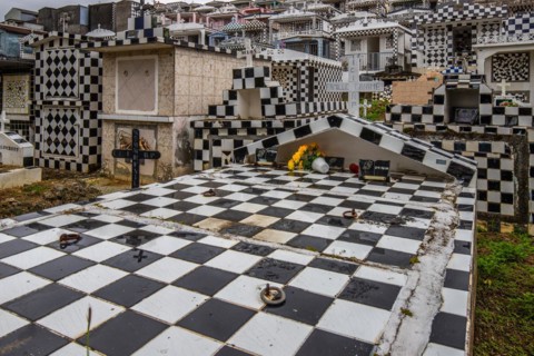 Famous cemetery, many mausoleums or large tombs decorated with tiles, often in black and white.