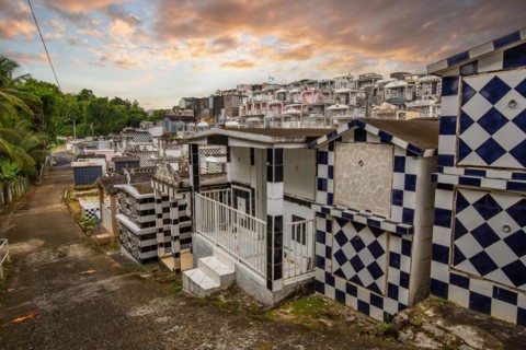 Famous cemetery, many mausoleums or large tombs decorated with tiles, often in black and white.