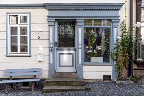 Historic shop around 1800, facade with bench and shop window, restored former restaurant and
