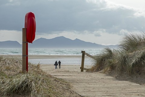 Life buoy, beach access, people, mountains, LLanddwyn Bay, Newborough, Isle of Anglesey, Wales,