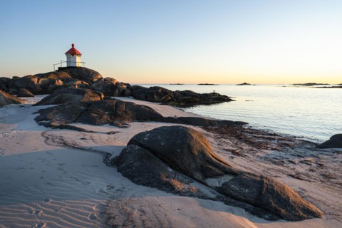 Seascape on the Lofoten Islands. The small lighthouse on the sandy beach of Eggum, sea and rocks.