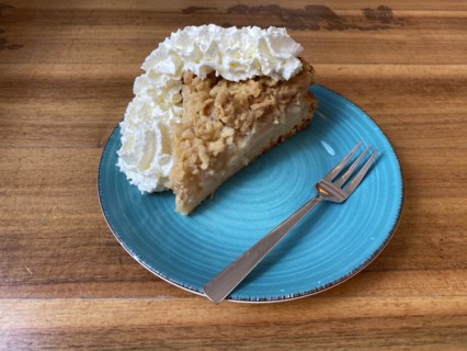 Piece of apple pie with whipped cream on plate, cake fork, wooden table, Frankfurt am Main, Hesse,