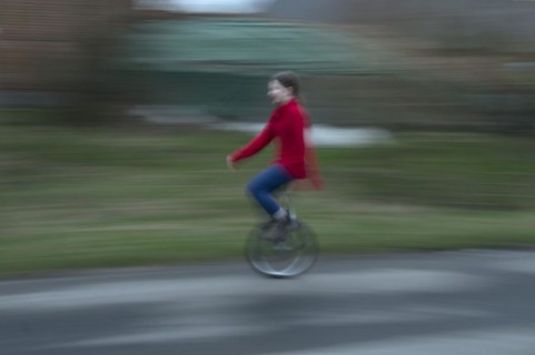 Girl, 10 years old, riding a unicycle, motion blur, Mecklenburg-Vorpommern, Germany, Europe