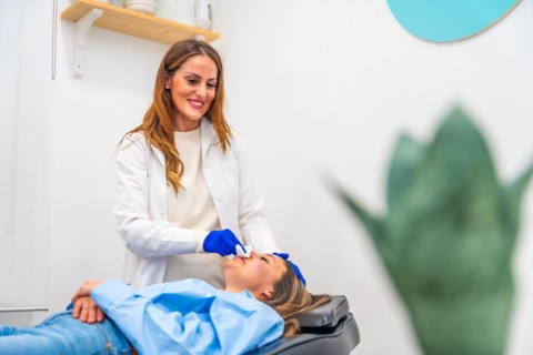 Woman relaxed on stretcher of a beautician clinic after treatment with hyaluronic acid