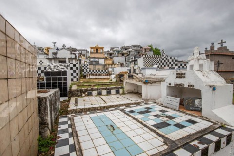 Famous cemetery, many mausoleums or large tombs decorated with tiles, often in black and white.