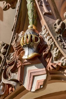 Coat of arms of the Lords of Eppstein with helmet and crest of peacock feathers above porch and