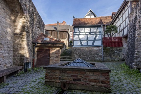 Historic town fountain at the Schelmenpforte on the town wall, 11th century, cultural monument,