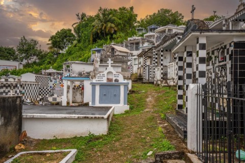 Famous cemetery, many mausoleums or large tombs decorated with tiles, often in black and white.