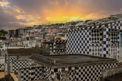 Famous cemetery, many mausoleums or large tombs decorated with tiles, often in black and white.