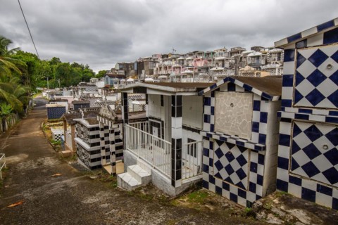 Famous cemetery, many mausoleums or large tombs decorated with tiles, often in black and white.