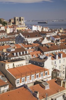 High angle view of buildings with traditional terracotta tiled rooftops in old Lisbon from Santa