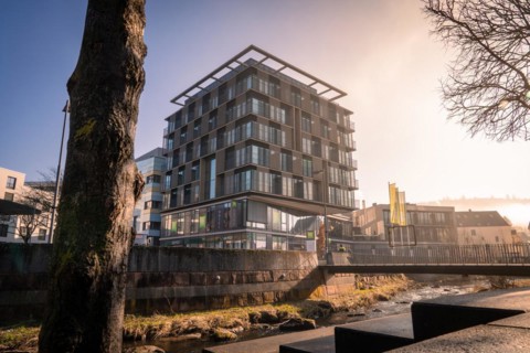 Ibis Styles Hotel, Modern architecture with reflection in a puddle, captured in daylight, sunrise,