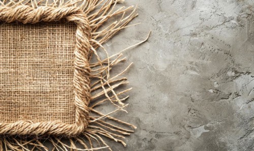 Delicate jute frame on minimalistic natural material, space for text, ecology nature background AI