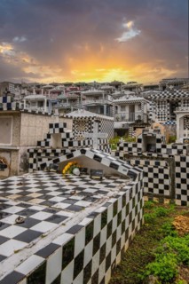 Famous cemetery, many mausoleums or large tombs decorated with tiles, often in black and white.
