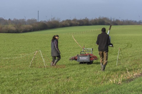 Shepherd and his daughter fence a new pasture with a solar panel for the electric fence,
