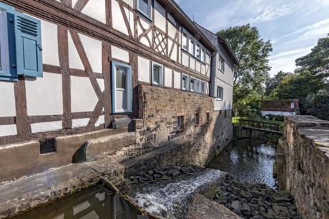 Former mill on the Muehlgraben, historic half-timbered house from around 1709, cultural monument,