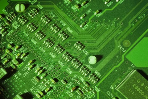 Close-up of green lighted electronic computer circuit board with lines, Studio Composition, Quebec,