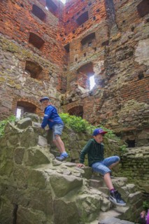 Two boys climbing in the tower in Hammershus which was Scandinavia's largest medieval fortification