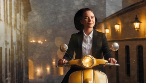 Woman on a vintage scooter on a rain-soaked street under ambient lights, blurry moody landscaped