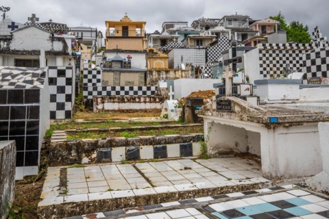 Famous cemetery, many mausoleums or large tombs decorated with tiles, often in black and white.