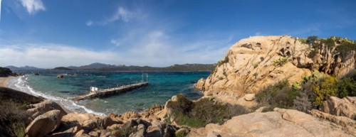 Rock formations, jetty leading into the sea, panoramic shot, Capriccioli beach, Costa Smeralda,