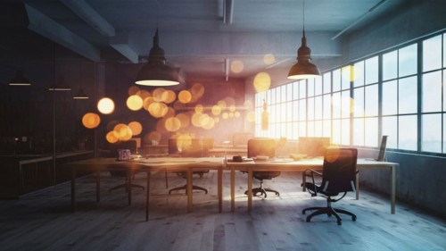 Office illuminated by pendant lights with reflective surfaces and lens flare at dusk, horizontal,