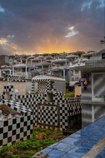 Famous cemetery, many mausoleums or large tombs decorated with tiles, often in black and white.