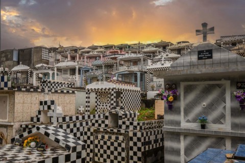 Famous cemetery, many mausoleums or large tombs decorated with tiles, often in black and white.