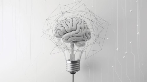 A textured brain forms the filaments of a light bulb surrounded by a wireframe geometric shape, ai