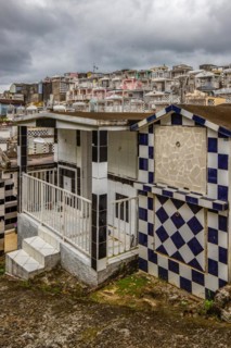 Famous cemetery, many mausoleums or large tombs decorated with tiles, often in black and white.