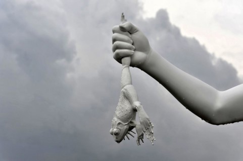 Charles Ray's statue of the boy with a frog on the top of the Zattere A surreal sculpture of a hand