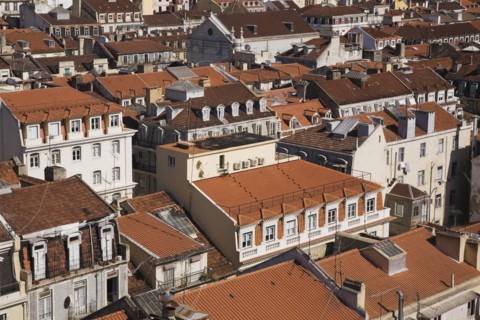 High angle view of buildings with traditional terracotta tiled rooftops in old Lisbon from Santa