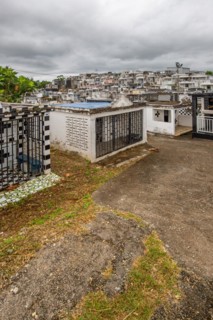 Famous cemetery, many mausoleums or large tombs decorated with tiles, often in black and white.