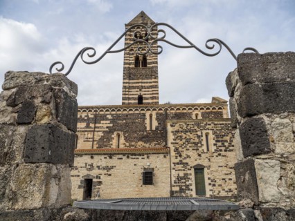 Fountain, behind the tower of the abbey church Santissima Trinita di Saccargia of the destroyed