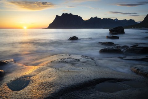 Seascape on the beach at Uttakleiv (Utakleiv), rocks in the foreground. Mount Hogskolmen in the
