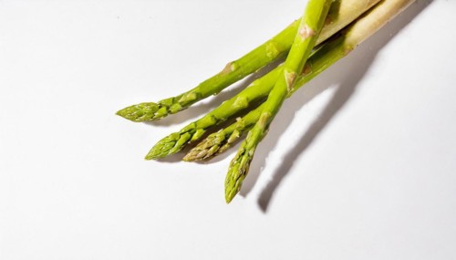 Fresh asparagus on white background with strong shadows and texture, AI generated, AI generated
