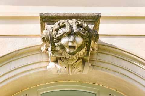 Mythical creature above archway, stone figure, face, Winnental Castle built in the 15th century by
