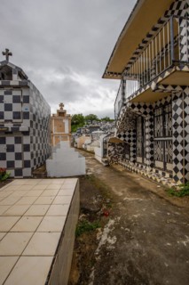 Famous cemetery, many mausoleums or large tombs decorated with tiles, often in black and white.