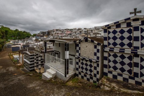Famous cemetery, many mausoleums or large tombs decorated with tiles, often in black and white.