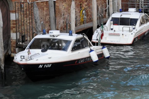 Boats of the Italian water police Carabinieri sailing through a canal in Venice, Venice, Veneto,
