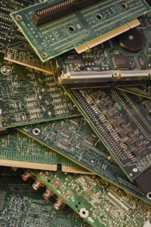 Close-up of various green electronic computer circuit boards with microchips, memory chips and hard