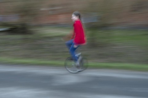 Girl, 10 years old, riding a unicycle, motion blur, Mecklenburg-Vorpommern, Germany, Europe