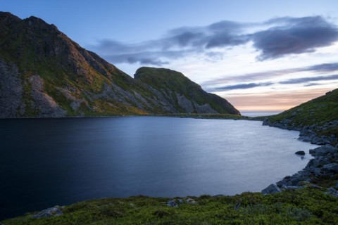 Lake Utdalsvatnet and the Hogskolmem mountain range. At night during the midnight sun in good