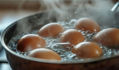 Eggs boiling in a pot of water, closeup view AI generated