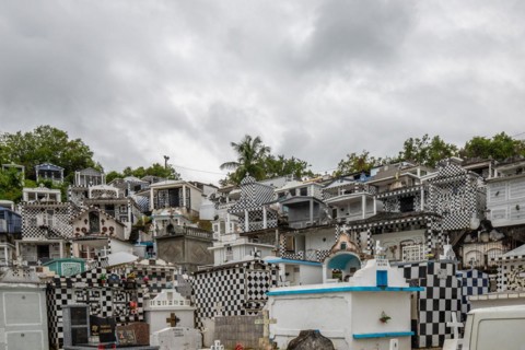 Famous cemetery, many mausoleums or large tombs decorated with tiles, often in black and white.