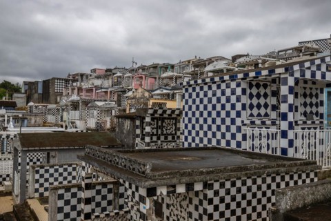 Famous cemetery, many mausoleums or large tombs decorated with tiles, often in black and white.