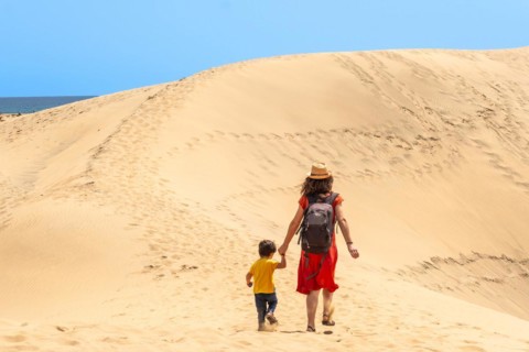 Mother and child on vacation in the dunes of Maspalomas, Gran Canaria, Canary Islands