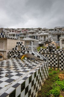 Famous cemetery, many mausoleums or large tombs decorated with tiles, often in black and white.