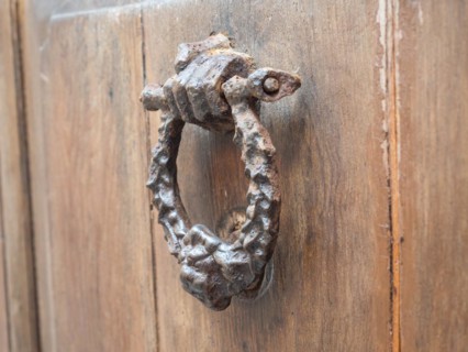 Hand holding door knocker, Alghero, Sardinia, Italy, Europe