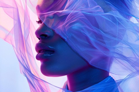 Close-up of a woman's face partially obscured by a blue sheer veil, AI generated